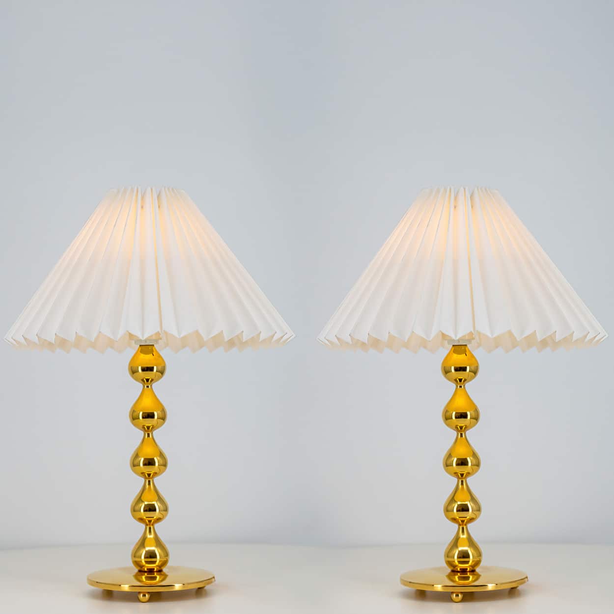 Pair of Asmussen 24 carat Gold plated Drops Table Lamps with Pleated Lampshade